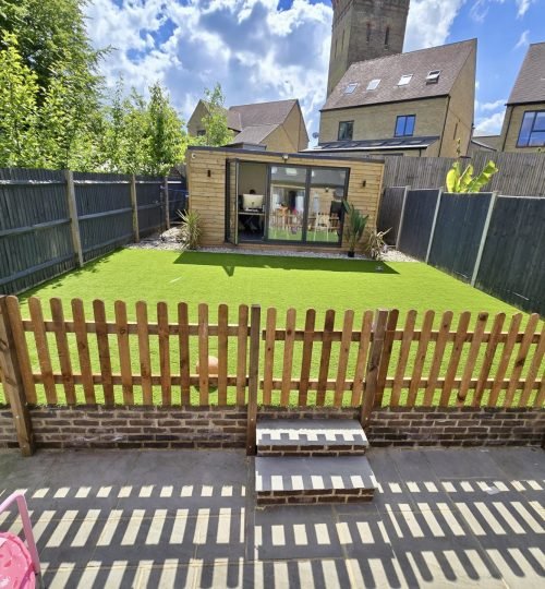 Transformed garden with artificial grass and picket fence
